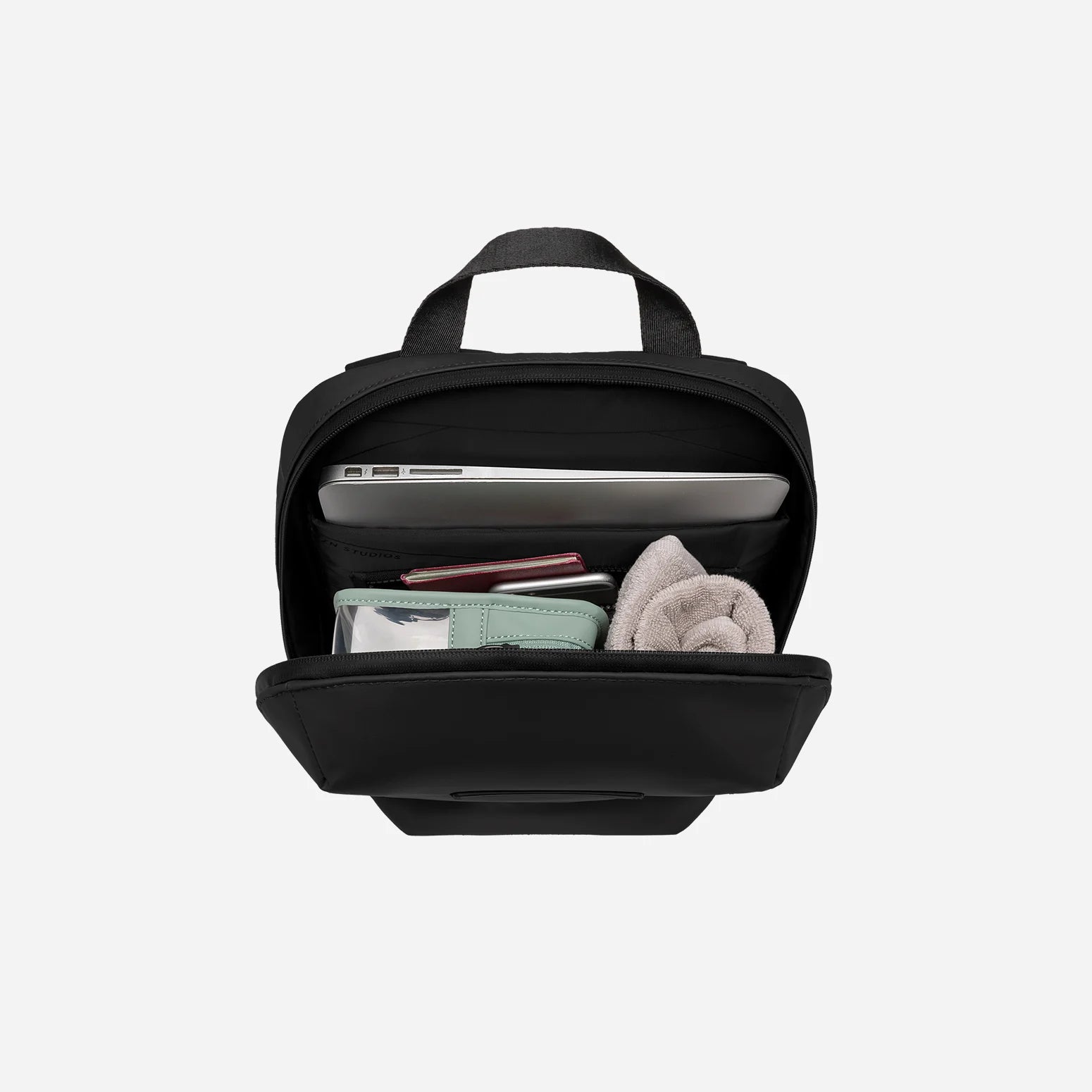 Minimalist slim waterproof backpack with luggage sleeve for work and travel 