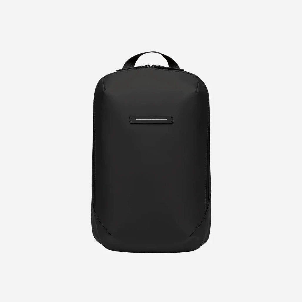 Minimalist slim waterproof backpack with luggage sleeve for work and travel 