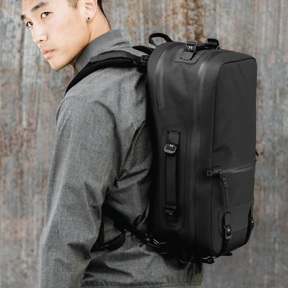 Waterproof minimalist backpack for laptop convertible with water bottle holder