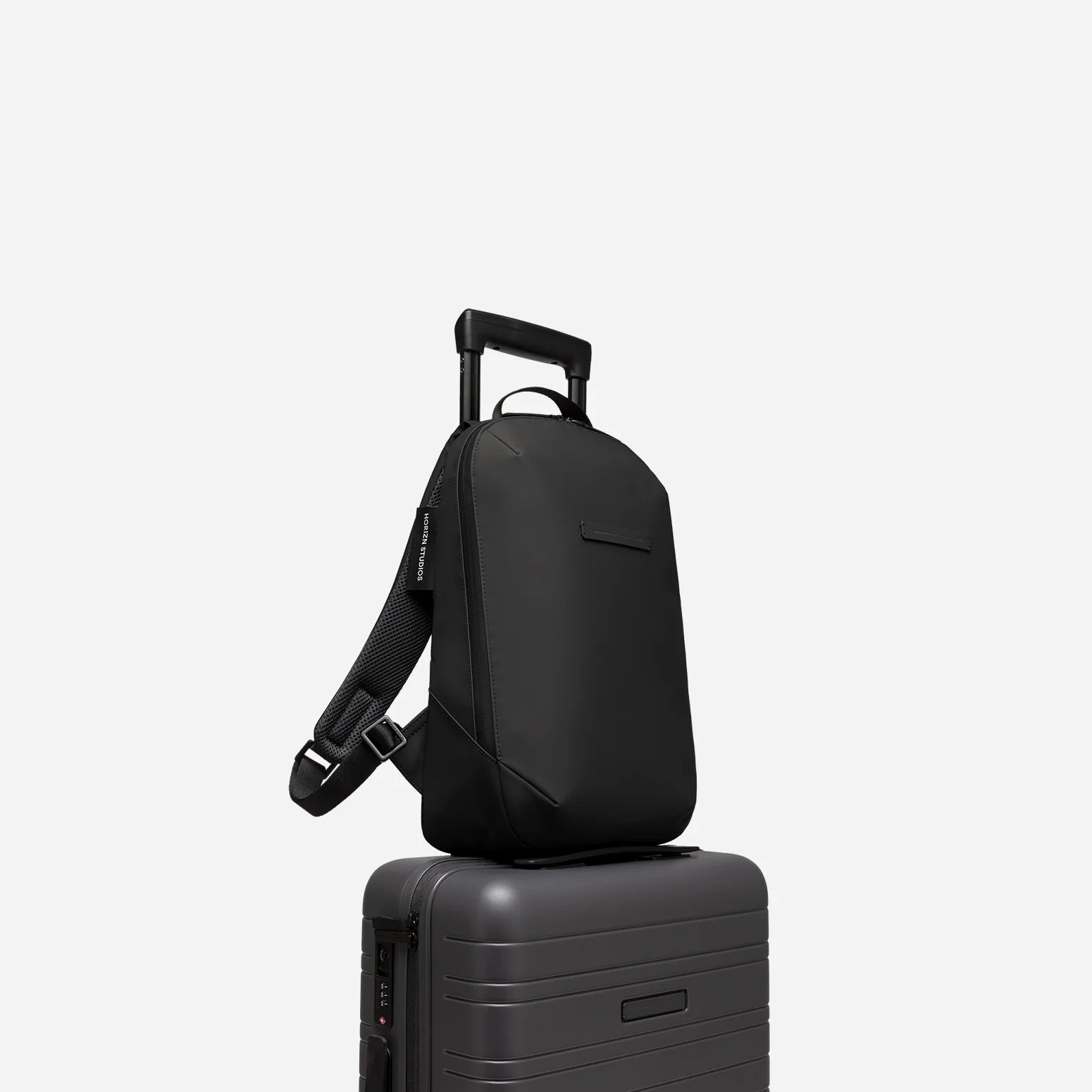 Minimalist slim waterproof backpack with luggage sleeve for work and travel 